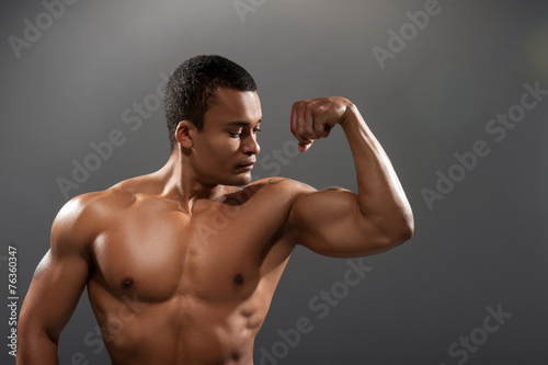 Young handsome African man posing shirtless