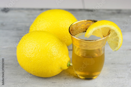 tea glass of lemon tea, on grey old wooden table