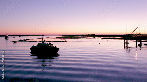 Sunset in Quatro-Aguas boat pier. Algarve