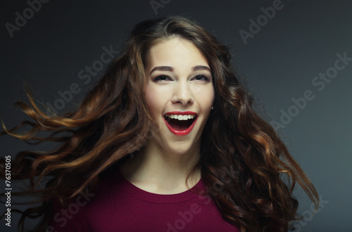 Fototapeta Naklejka Na Ścianę i Meble -  Young happy woman with wind in hair