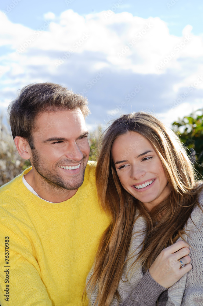 Happy young couple in love at the park in autumn