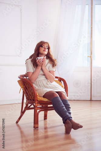 Young woman drinking coffee or tea