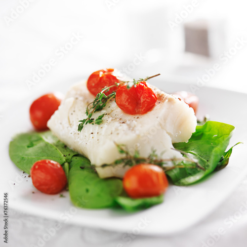halibut on spinach on white plate