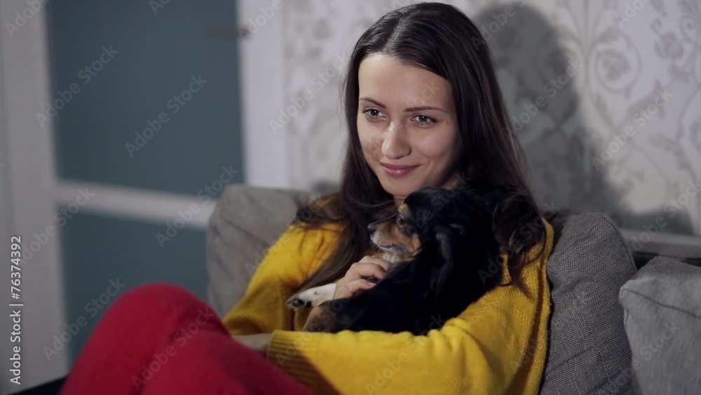 Woman watching TV with a Small Dog Woman watching TV with a Small Dog