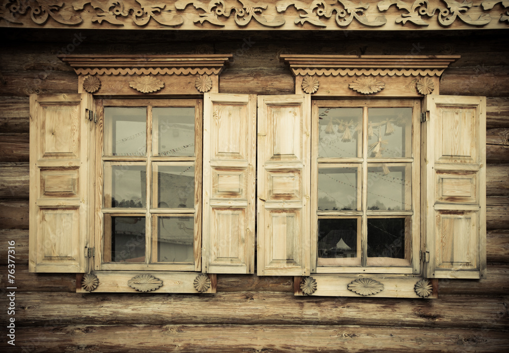 Windows with shutters, patterned on the wall of the old wooden h Windows with shutters, patterned on the wall of the old wooden h