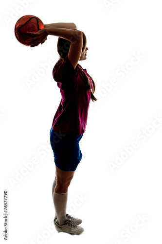 silhouette of girl playing football