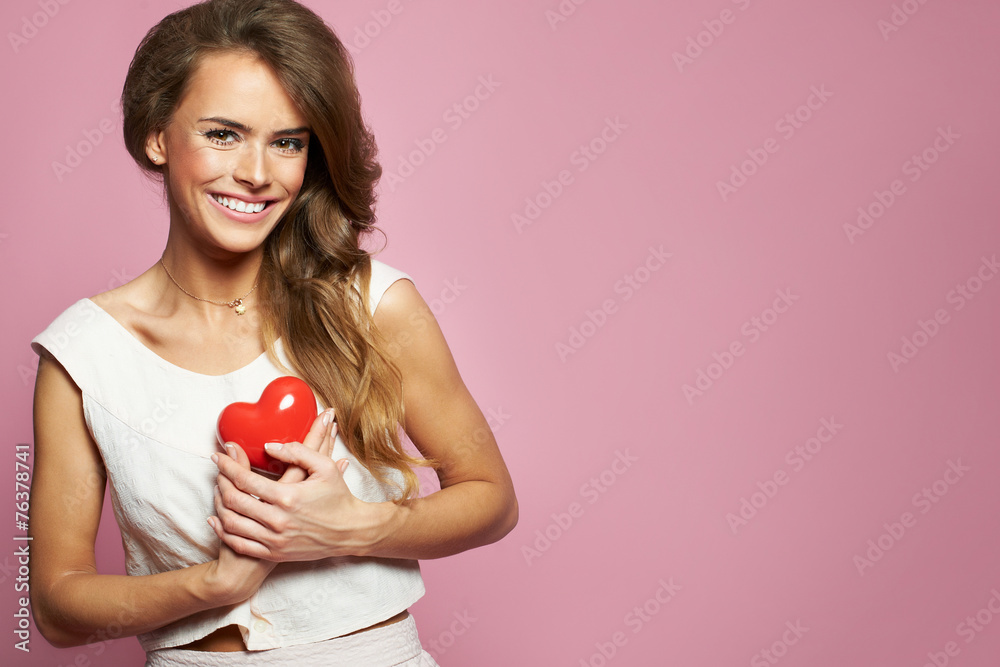 Smiling playful woman with a red heart - Valentines Day Smiling playful woman with a red heart - Valentines Day