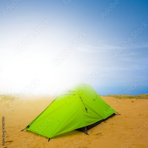 green touristic tent in a desert