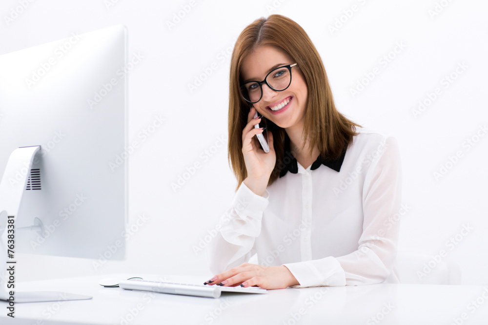 Happy businesswoman talking on the phone at office Happy businesswoman talking on the phone at office