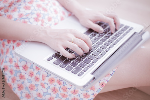 Asian woman using laptop at home