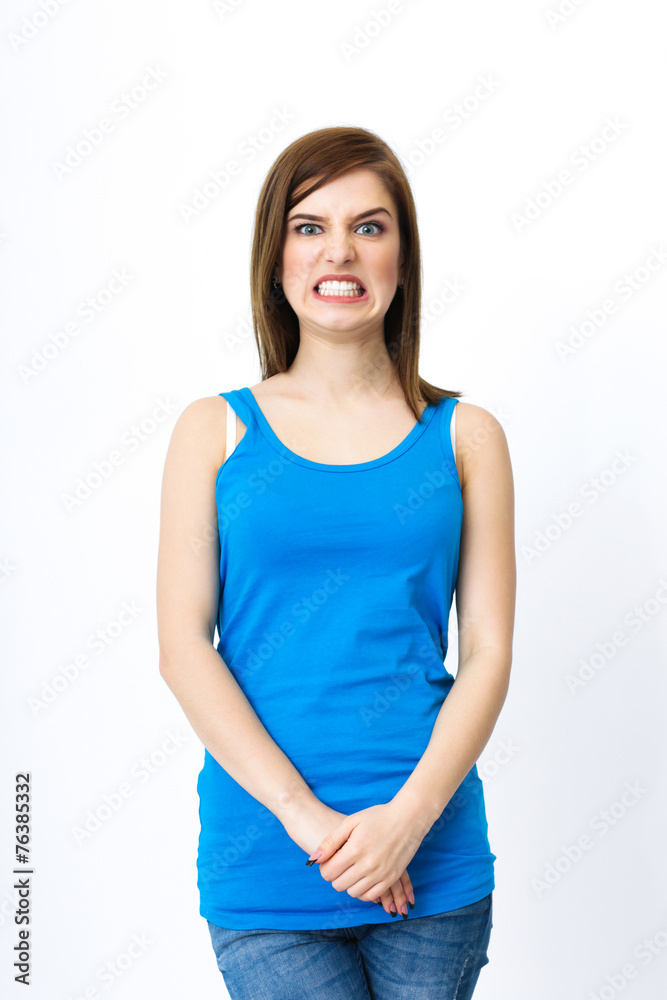 Portrait of a angry woman standing over gray background Portrait of a angry woman standing over gray background