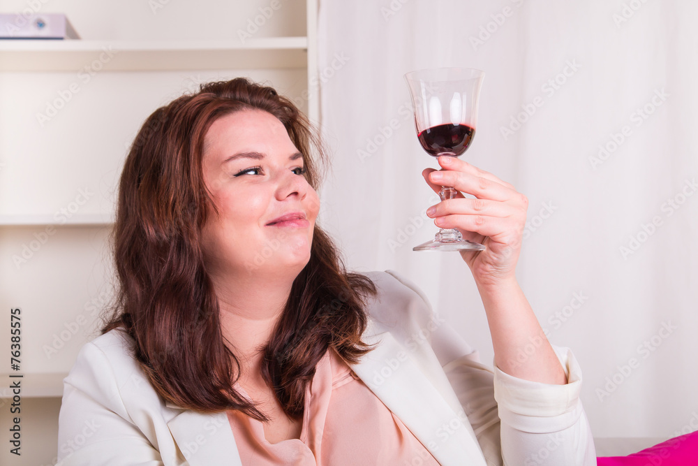 Young woman tests a glass of red wine Young woman tests a glass of red wine