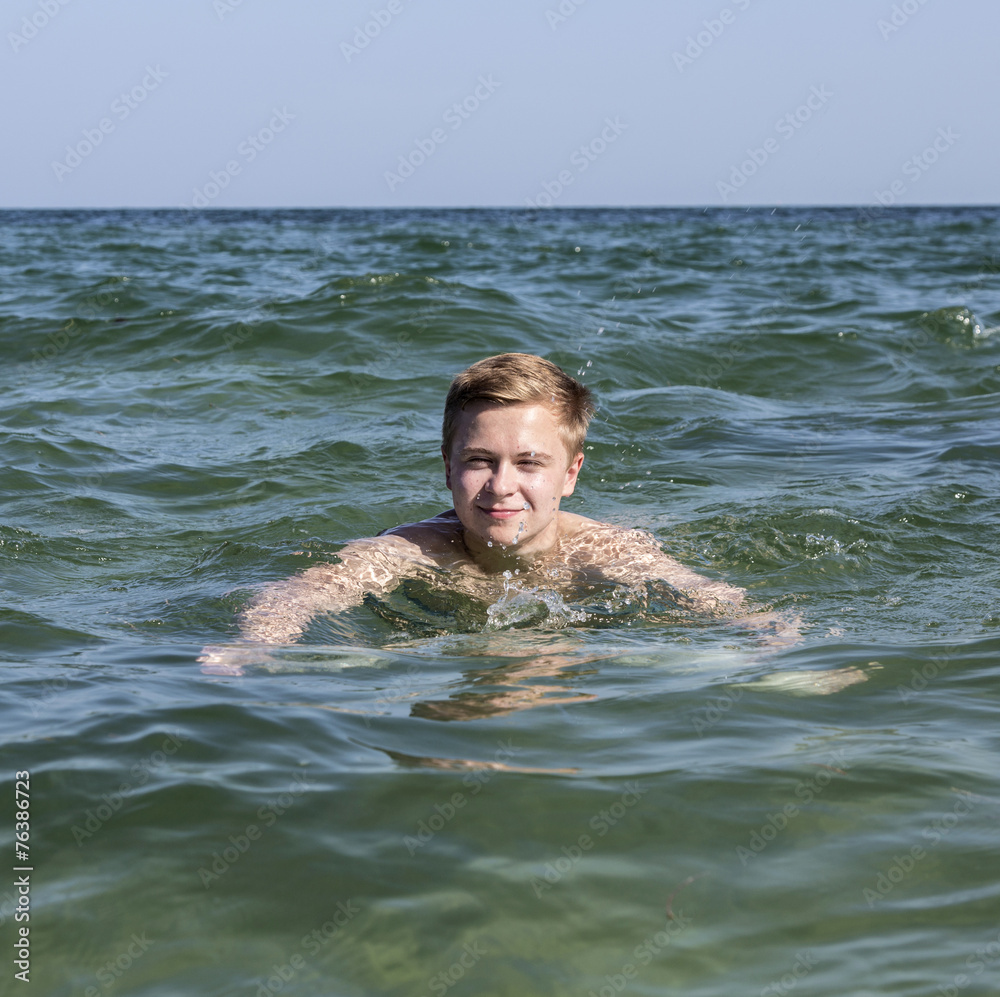 custom made wallpaper toronto digitalhandsome teen has fun swimming in the ocean