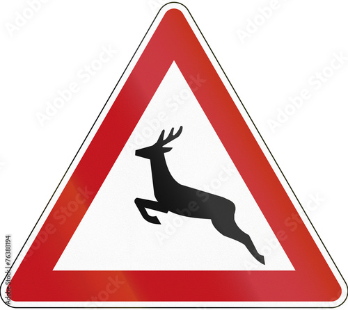 German sign warning about wild animals like deer crossing the road photo