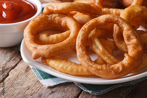 Deep fried onion rings and ketchup horizontal
