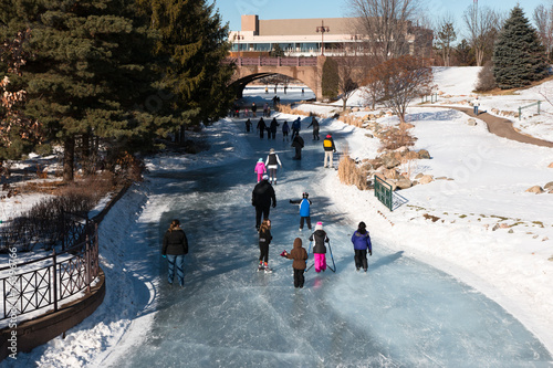 People ice skating on a frozen lake