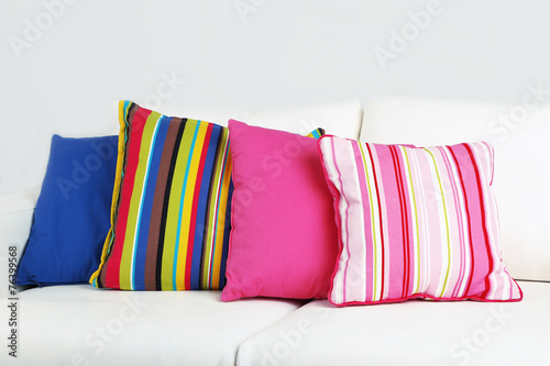 White sofa with colorful pillows in room