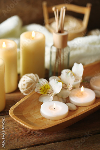 Composition of spa treatment, candles in bowl with water