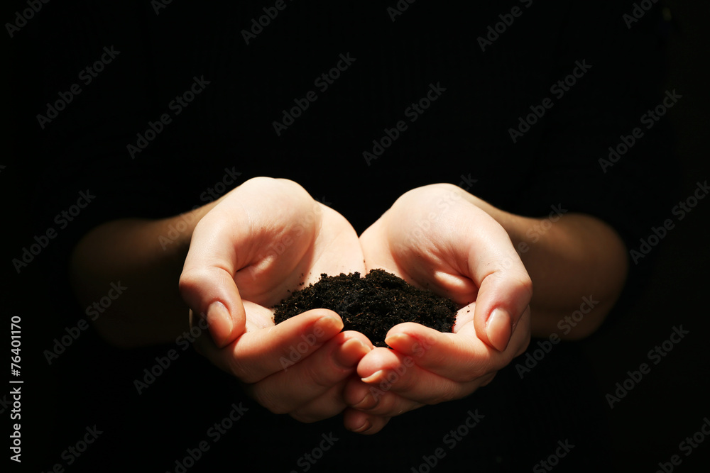 Handful of soil on dark background Handful of soil on dark background