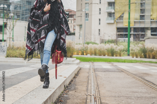 Detail of a young woman posing in the city streets