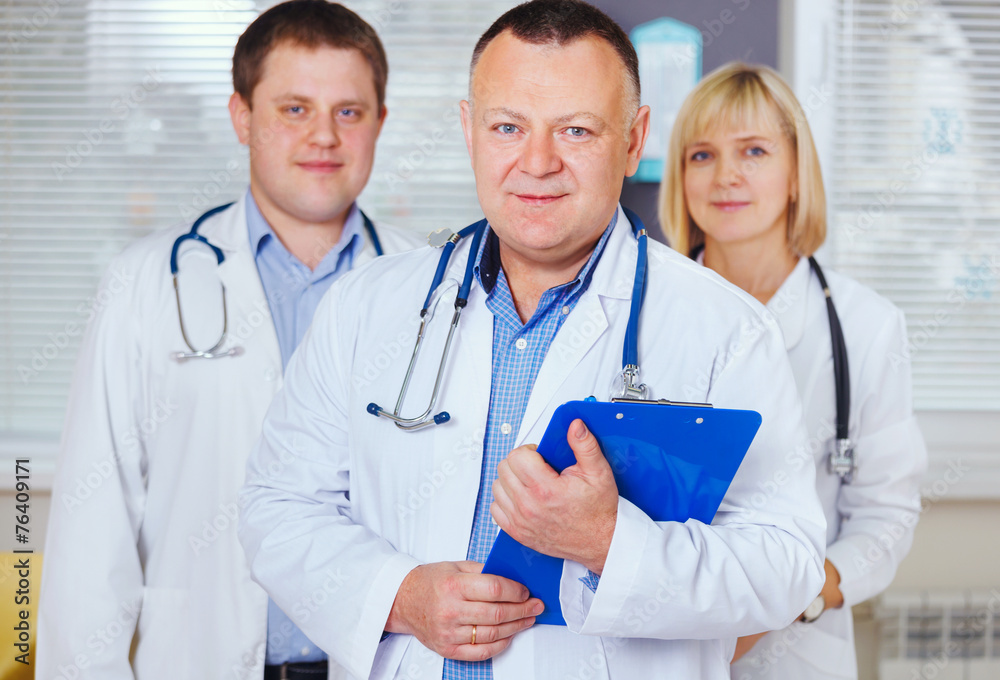 Group of happy doctors looking at camera. Group of happy doctors looking at camera.