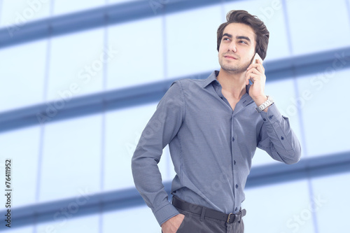 Young businessman talking mobile phone