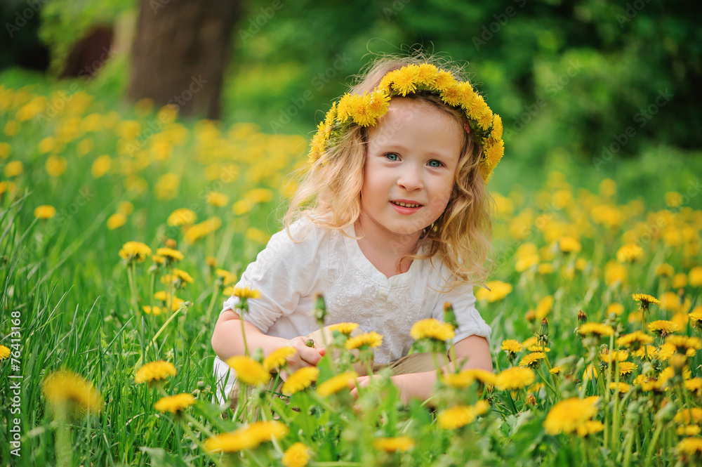 spring portrait of happy child girl in wreath on dandelion field spring portrait of happy child girl in wreath on dandelion field