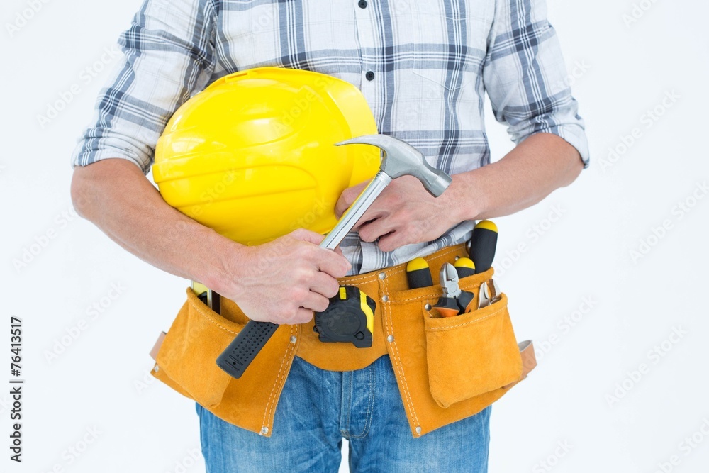 Technician holding hammer and hard hat