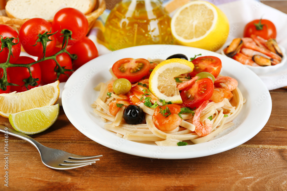 Tasty pasta with shrimps, mussels, black olives and tomato Tasty pasta with shrimps, mussels, black olives and tomato