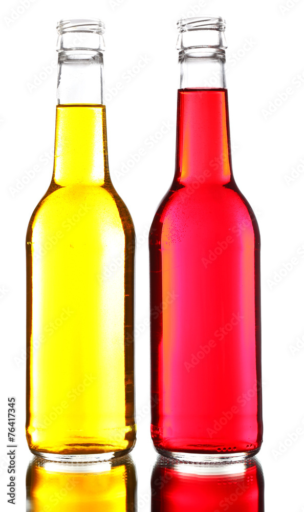 Colorful alcoholic beverages in glass bottles isolated on white Colorful alcoholic beverages in glass bottles isolated on white