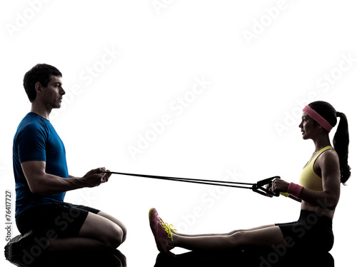 woman exercising fitness resistance  rubber band with man coach photo