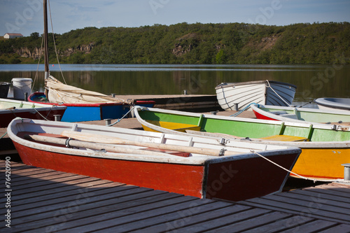 Color Wooden Boats with Paddles in a Lake