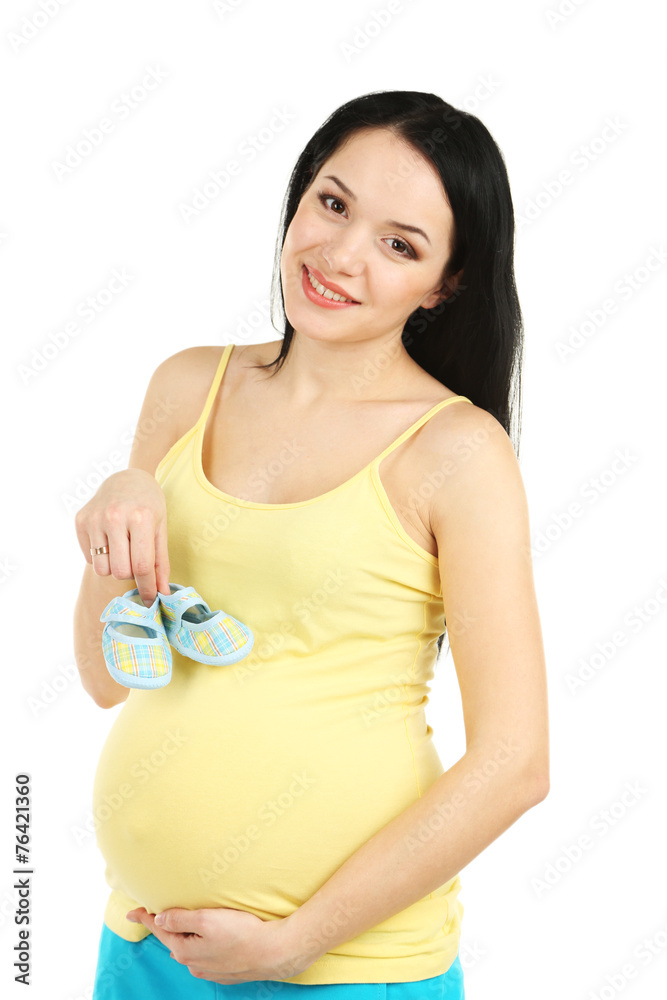 Beautiful young pregnant woman with baby boots isolated on