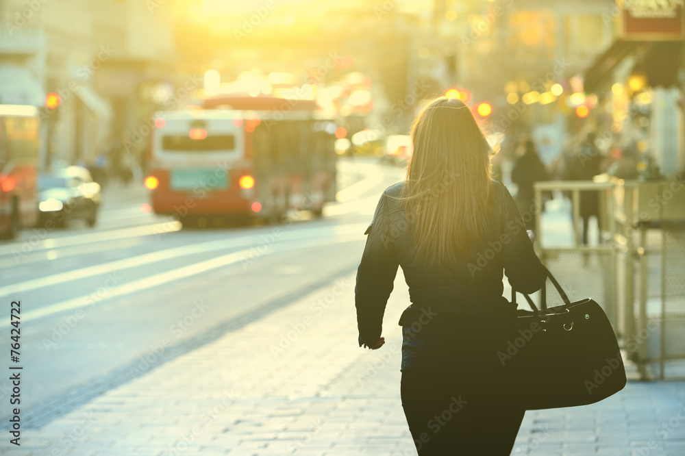 Woman on sidewalk in the absolute sunset Woman on sidewalk in the absolute sunset