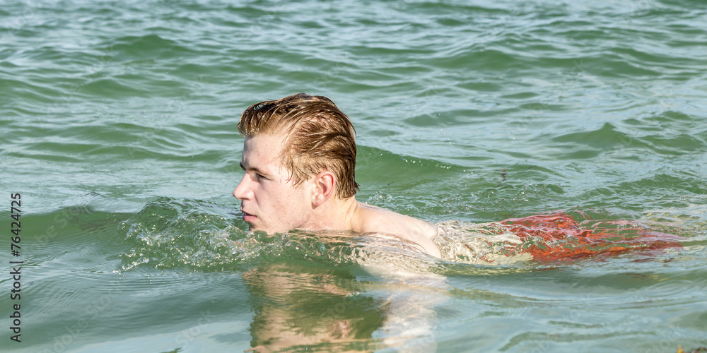 teenage boy enjoys swimming