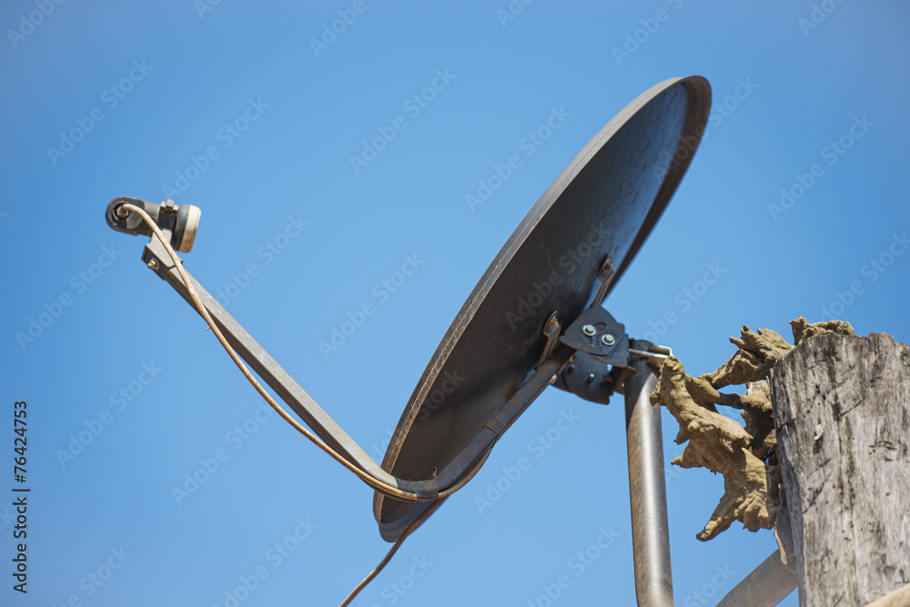Black satellite antenna dish on the roof Black satellite antenna dish on the roof