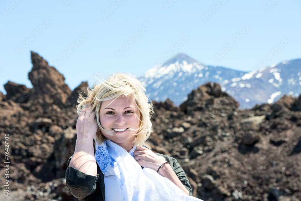 Smiling blond woman with Teide volcano on background Tenerife Sp