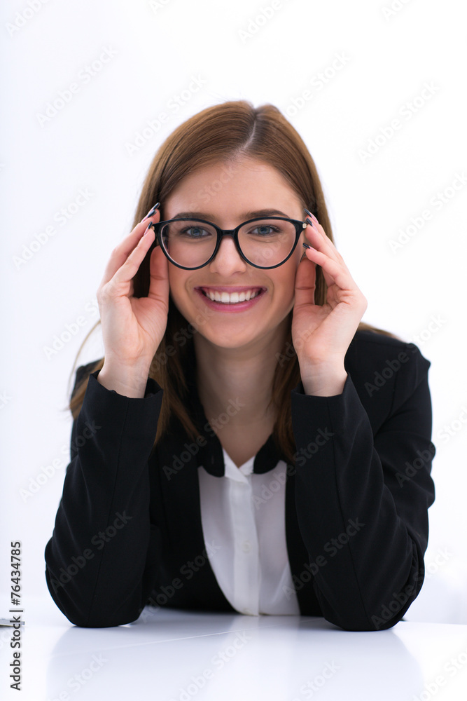 Happy businesswoman in glasses sitting at the table Happy businesswoman in glasses sitting at the table