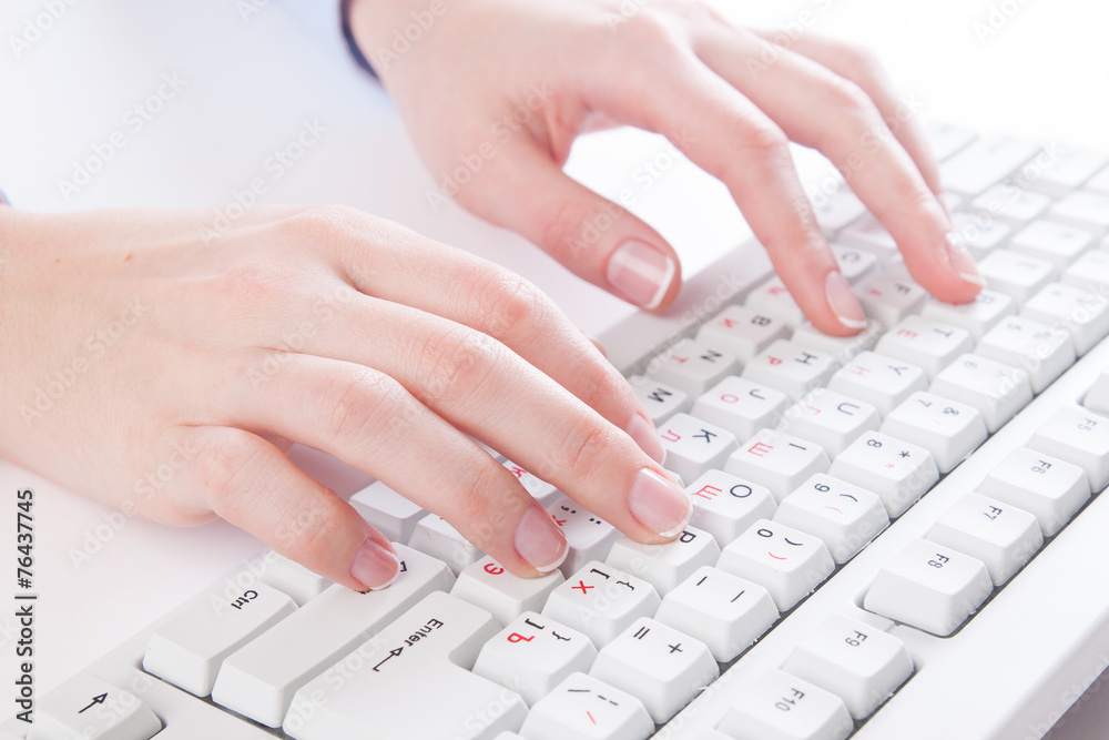 young woman typing on a keyboard young woman typing on a keyboard