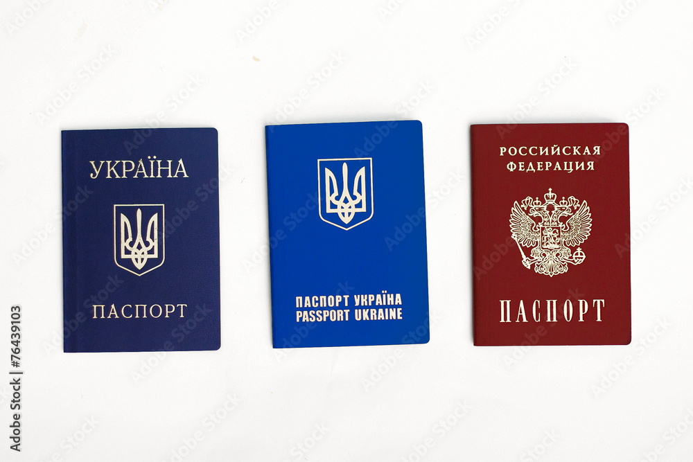 Ukrainian and Russian passports on white Ukrainian and Russian passports on white