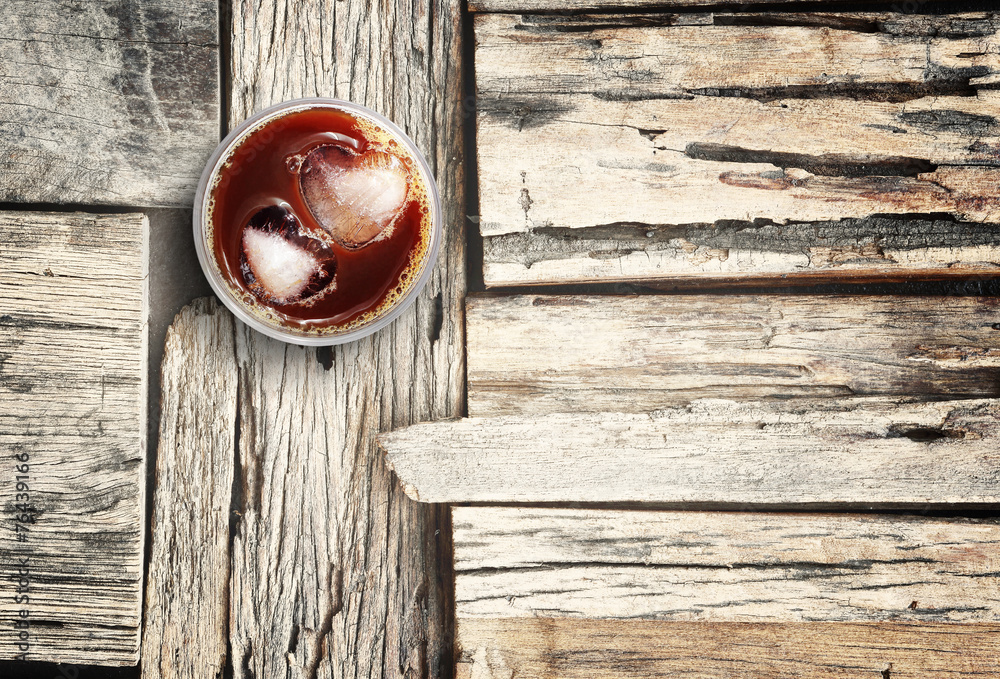 Iced coffee and ices in heart shape on wood floor, background fo Iced coffee and ices in heart shape on wood floor, background fo