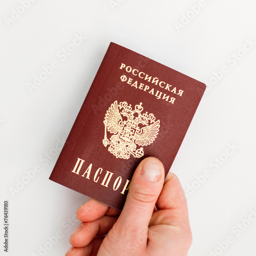 Russian passport in hand on a white background