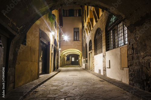 Beautiful narrow street with arch © miklyxa