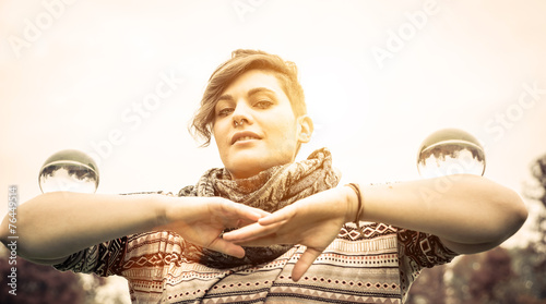 girl holding two contact juggling spheres