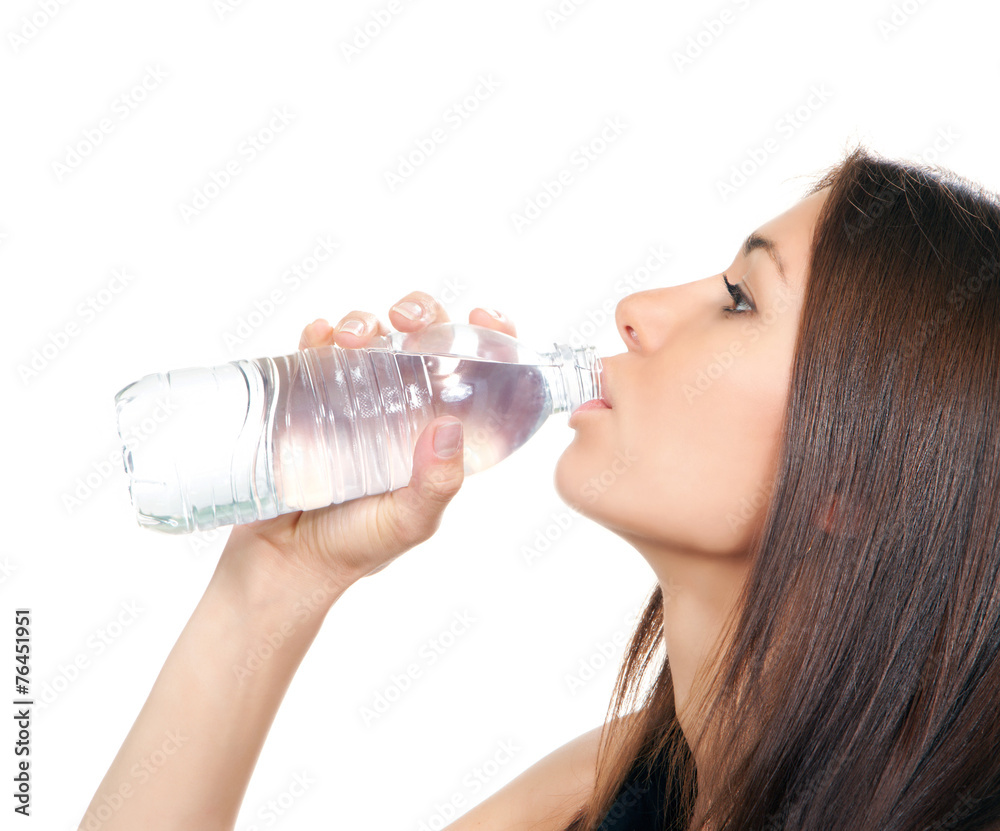 Woman drinking water from plastic bottle Woman drinking water from plastic bottle