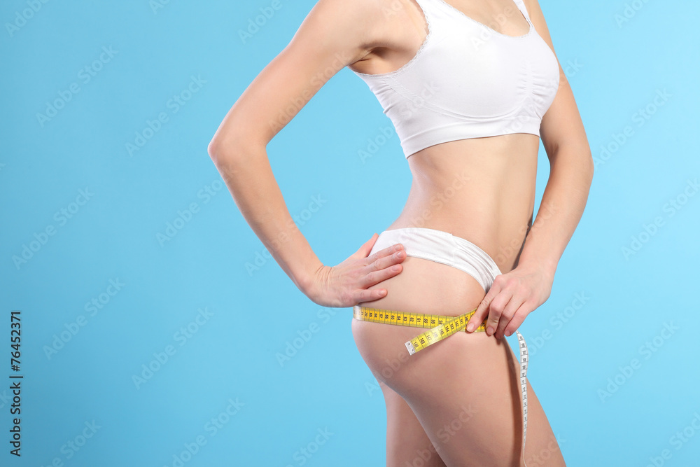 woman with measure tape over white