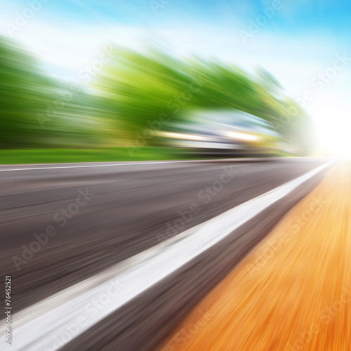 Car in motion blur on the road. © Elena Volkova