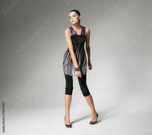 full-length fashion shot of girl with posing in light background 