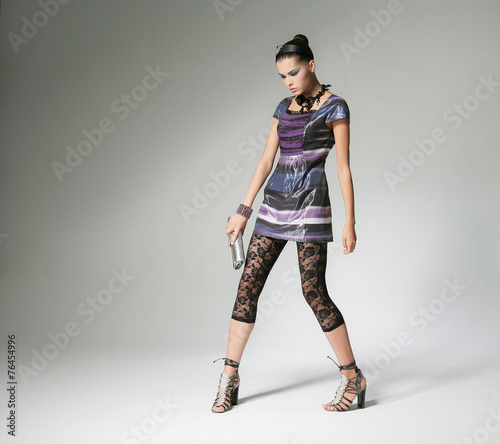 full-length fashion shot of girl with posing in light background 