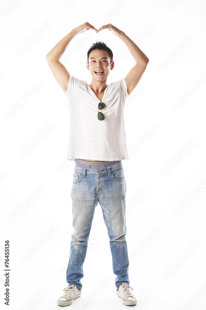 Fototapeta premium Asian man in love,showing hand in heart shape